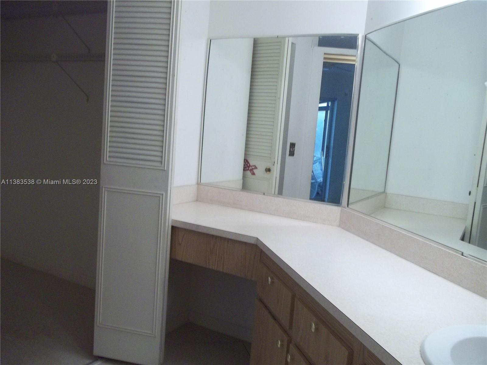 141 Arrowhead Circle Jupiter, FL 33458 - Photo 14 of 25 a bathroom with a sink and a mirror