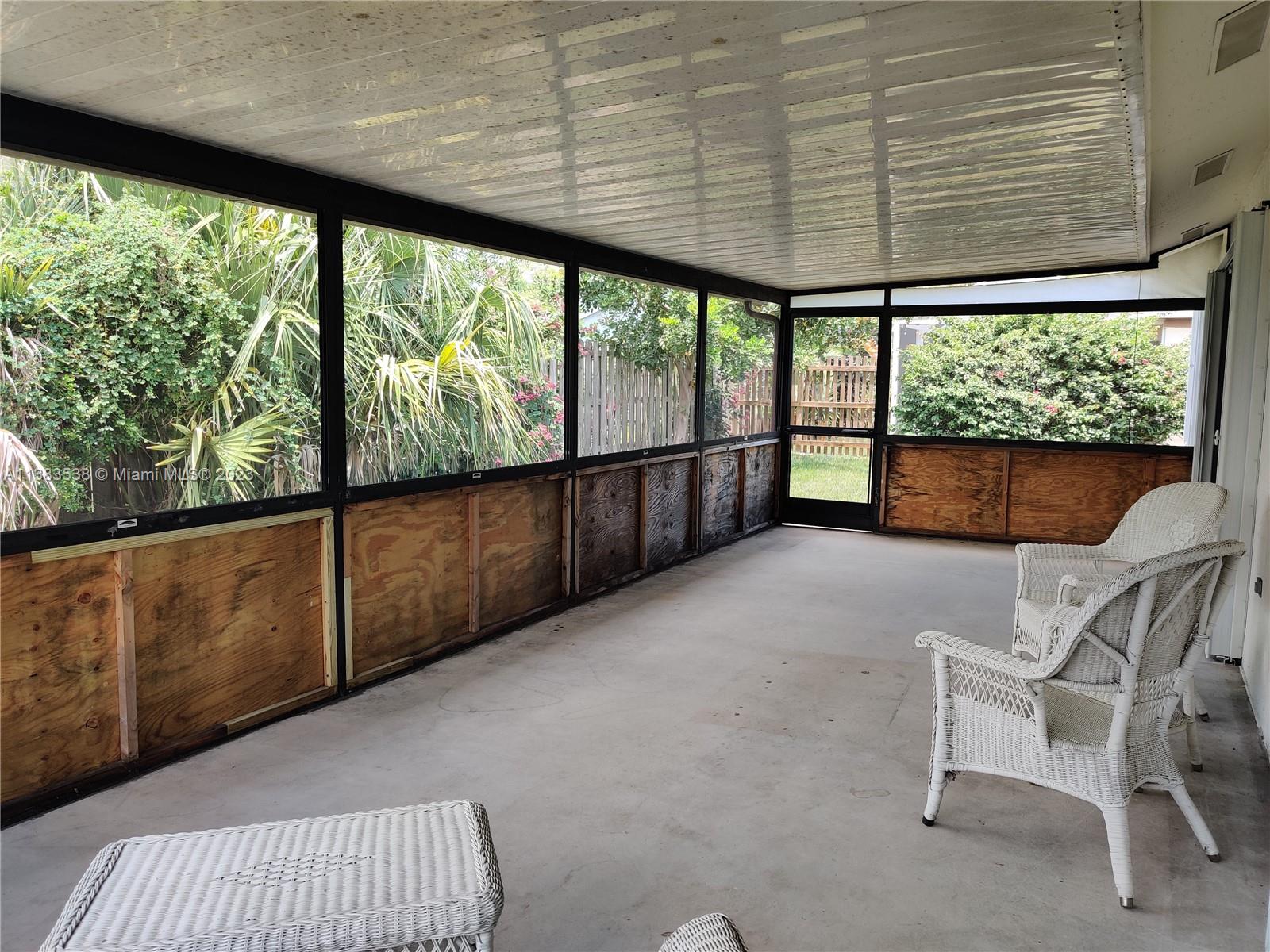 141 Arrowhead Circle Jupiter, FL 33458 - Photo 19 of 25 a view of front door with outdoor seating