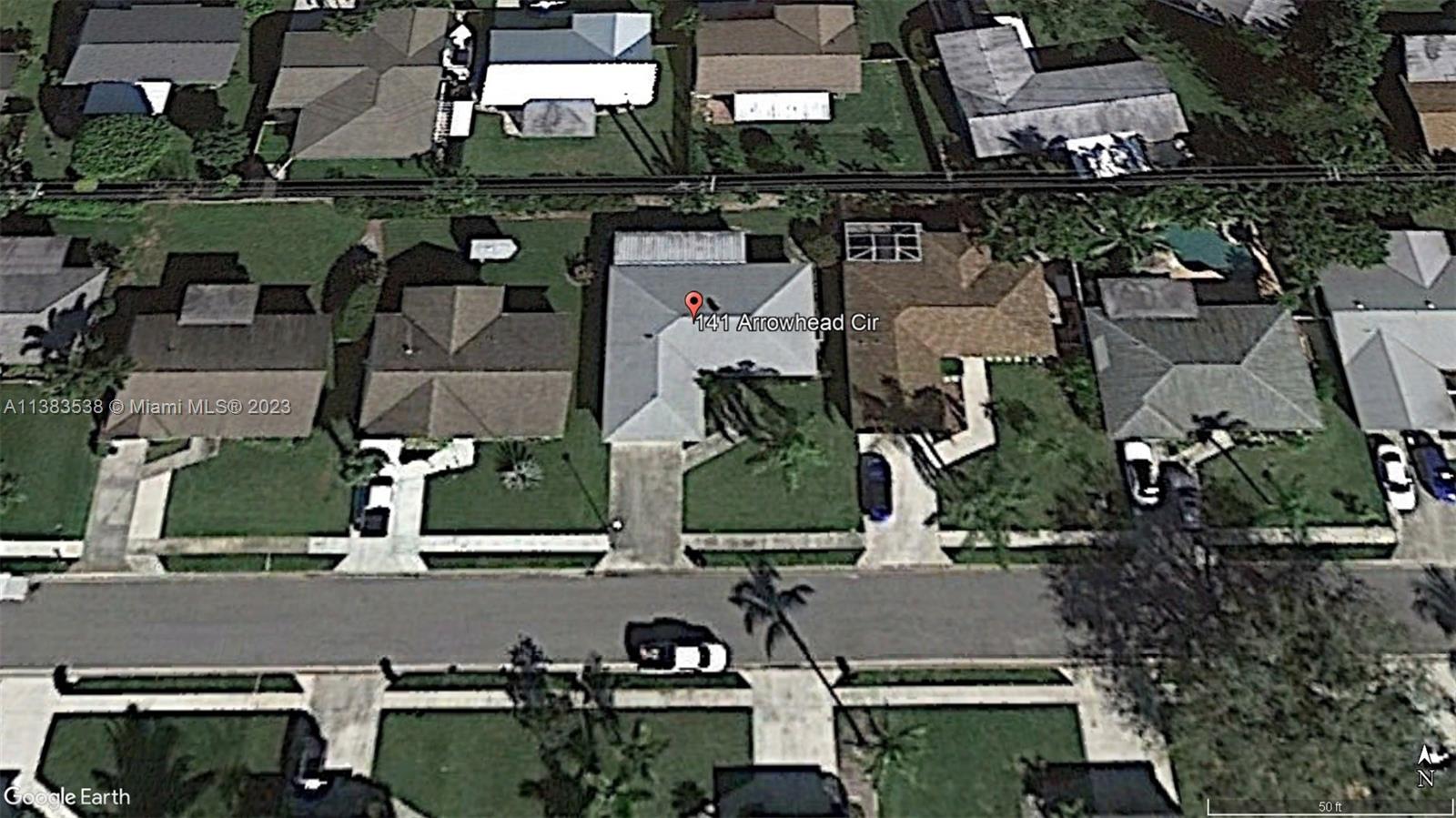 141 Arrowhead Circle Jupiter, FL 33458 - Photo 2 of 25 an aerial view of houses with outdoor space