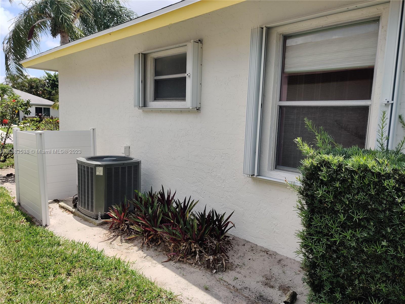 141 Arrowhead Circle Jupiter, FL 33458 - Photo 24 of 25 a couple of table and chair in front of house