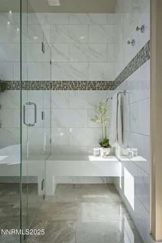 a living room with furniture chandelier and a large window