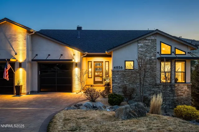an aerial view of a house with a yard and garden