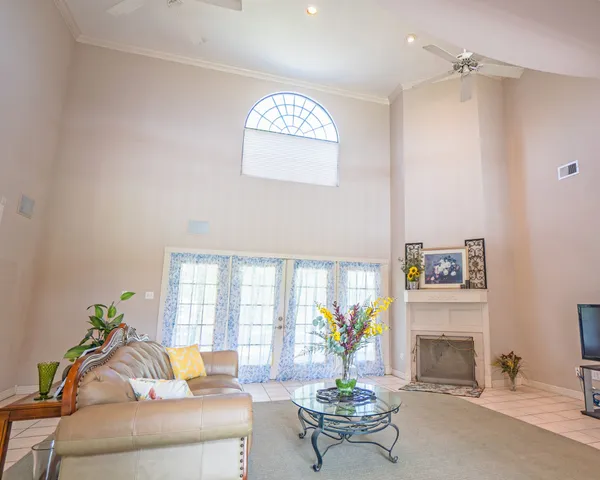 a living room with furniture and a book shelf