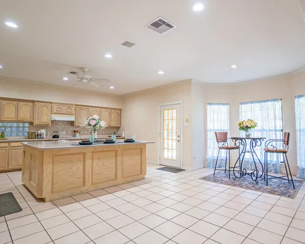 a view of a dining room with furniture and a window