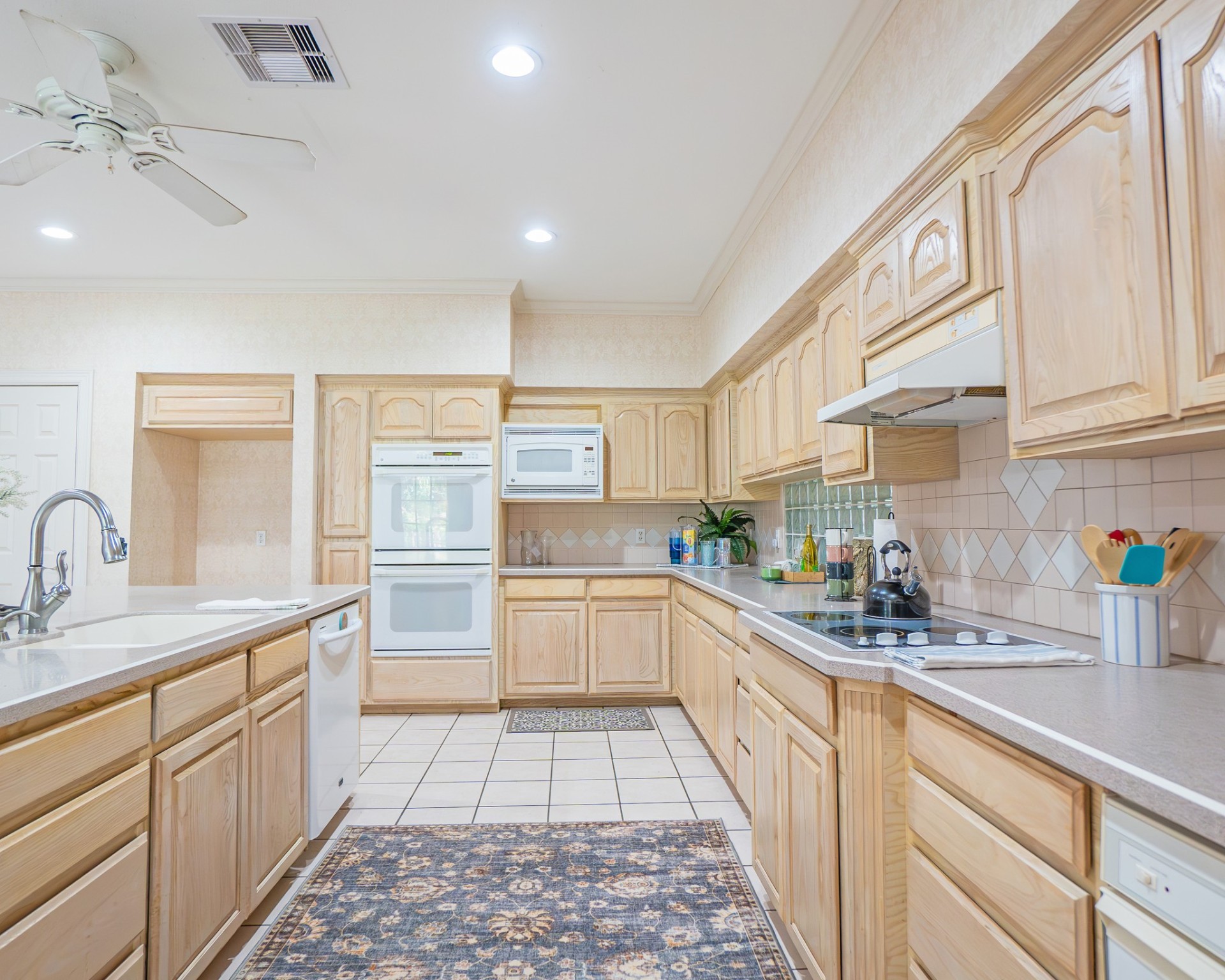 214 Williams Road Bay City, TX 77414 - Photo 30 of 48 a kitchen with a sink dishwasher stove and white cabinets with wooden floor