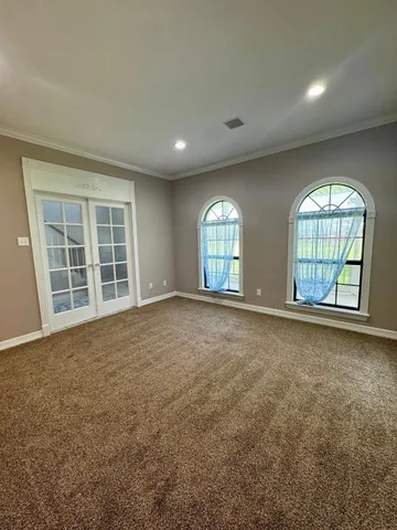 a spacious bedroom with a bed and a couch