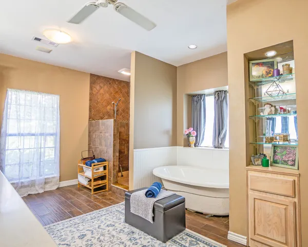 a large bathroom with a large tub sink and window