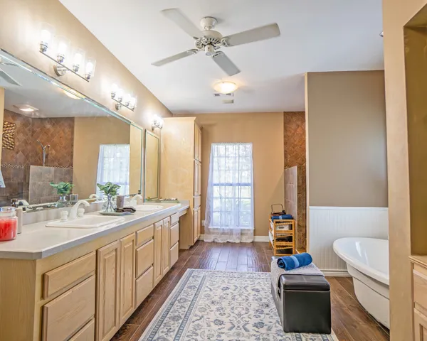 a bathroom with a tub shower and sink