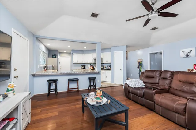a living room with furniture and kitchen view
