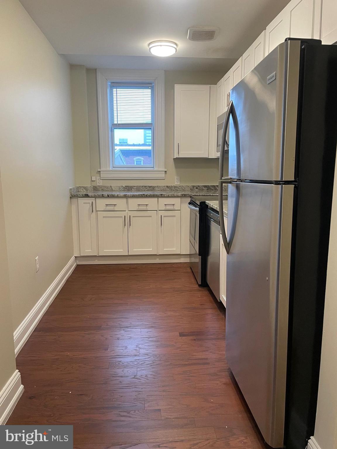 306 Cooper Street, Unit 505 Camden, NJ 08102 - Photo 8 of 19 a kitchen with a refrigerator and a sink