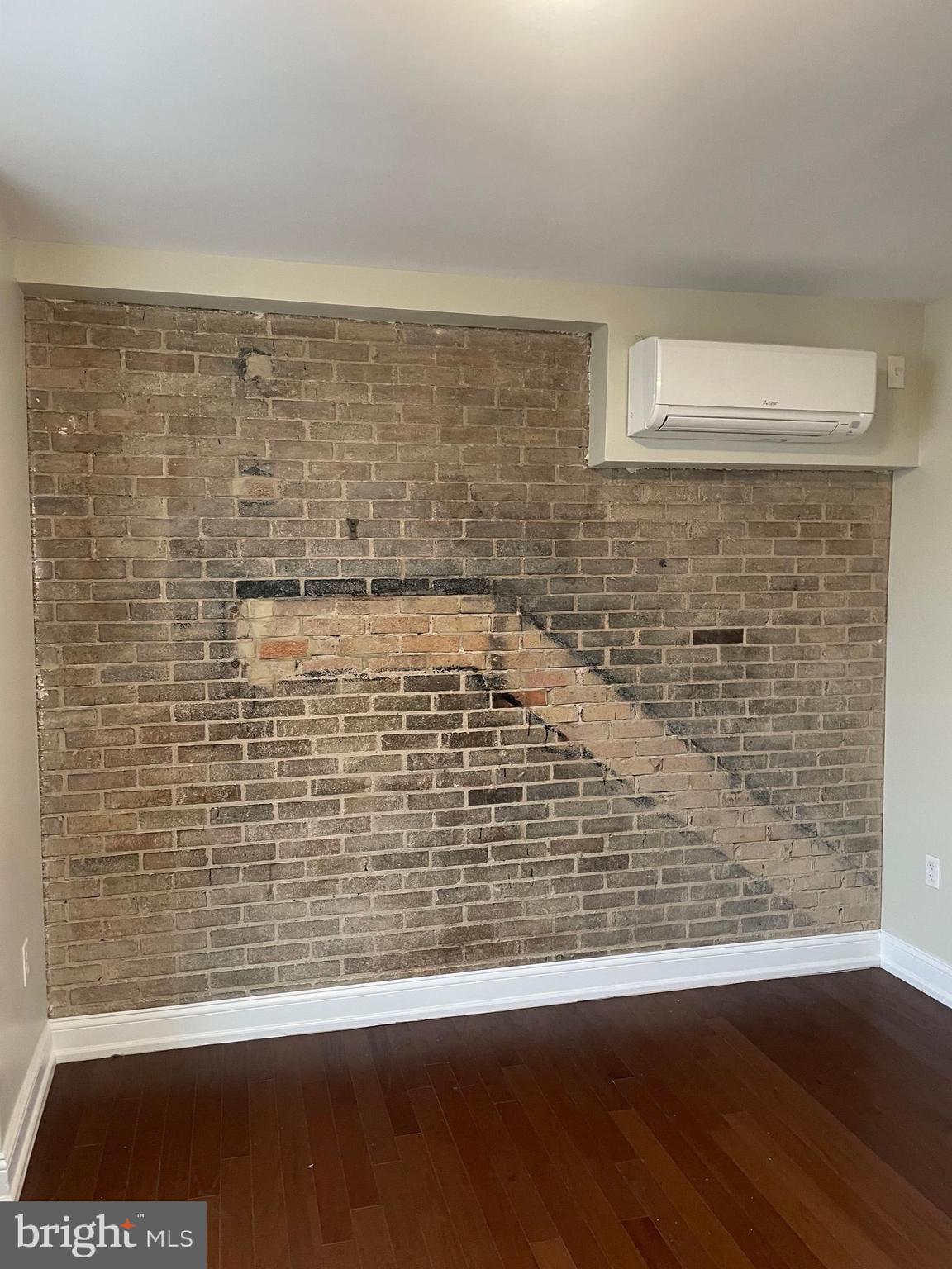 306 Cooper Street, Unit 505 Camden, NJ 08102 - Photo 10 of 19 a view of a brick wall with wooden floor