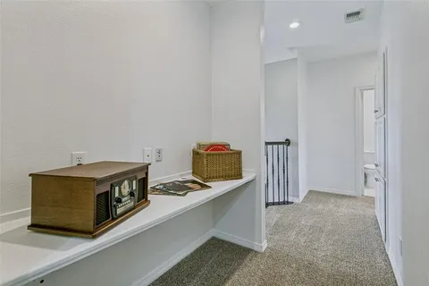 an empty room with a chandelier fan and windows