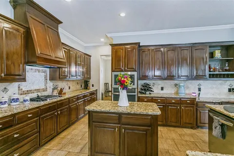 a kitchen with a sink a stove and cabinets