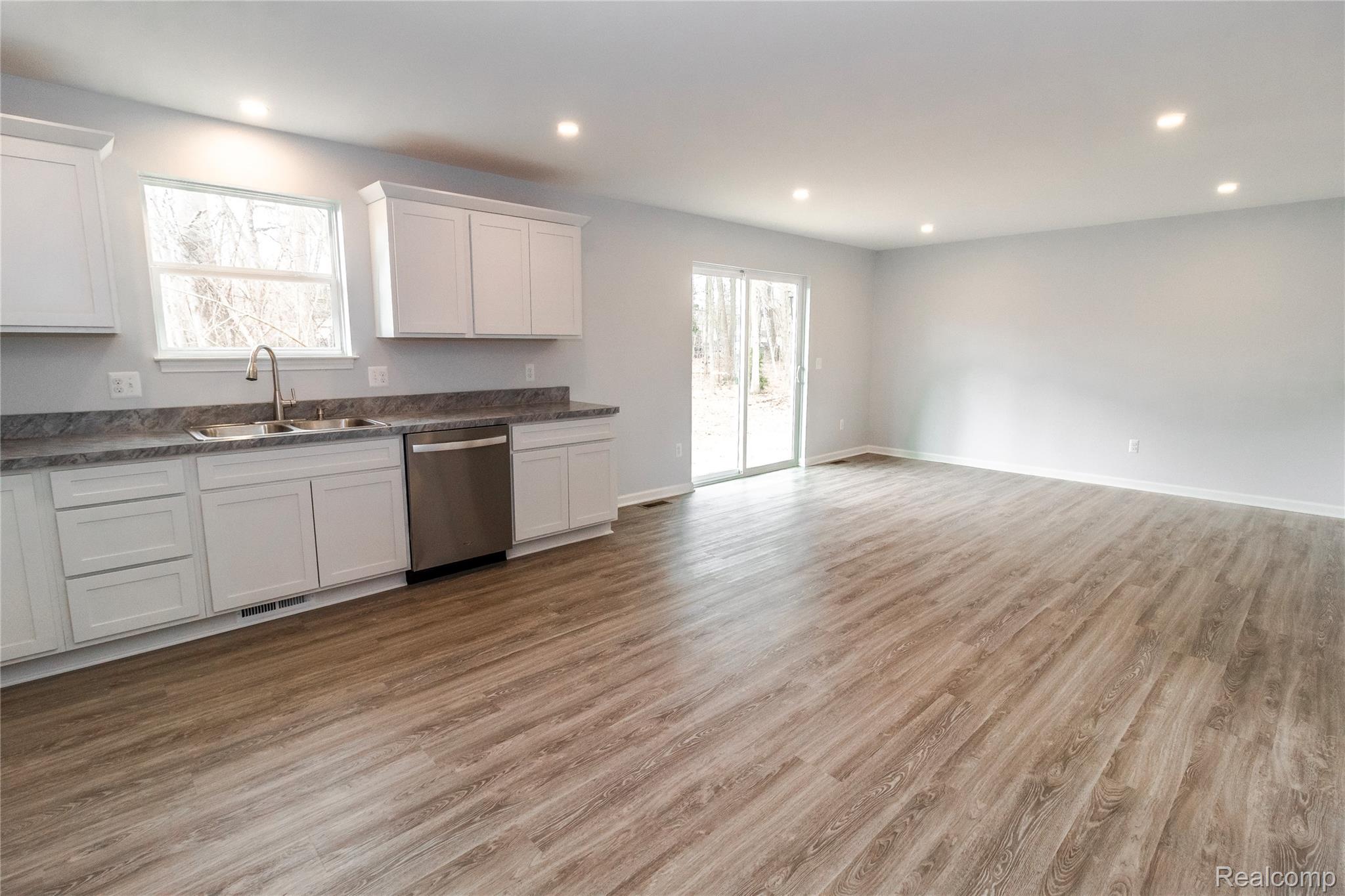 5155 Coldwater Road Lapeer, MI 48446 - Photo 5 of 24 Kitchen with white cabinets, dark countertops, dishwasher, light wood-style floors, and recessed lighting