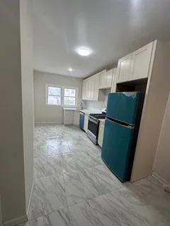 a kitchen with sink and refrigerator