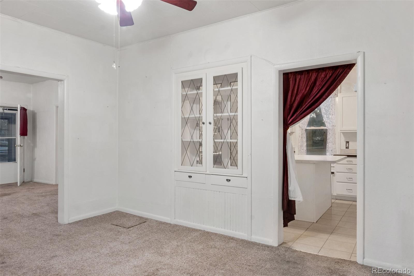 101 3rd Street Ramah, CO 80832 - Photo 5 of 24 an empty room with ceiling fan and windows