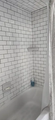 a bathroom with a white wall