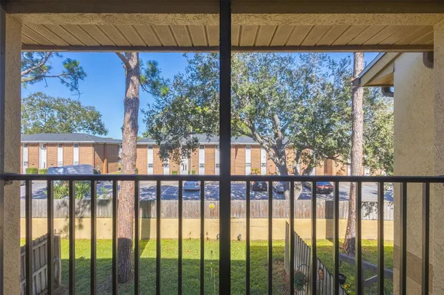 a view of a porch with a floor to ceiling window and outside view