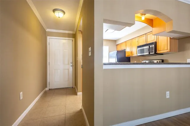 a view of a kitchen from a hallway