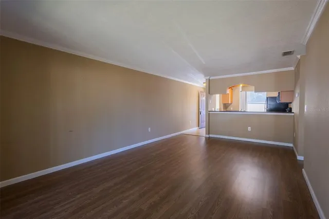 a view of wooden floor and windows in a room