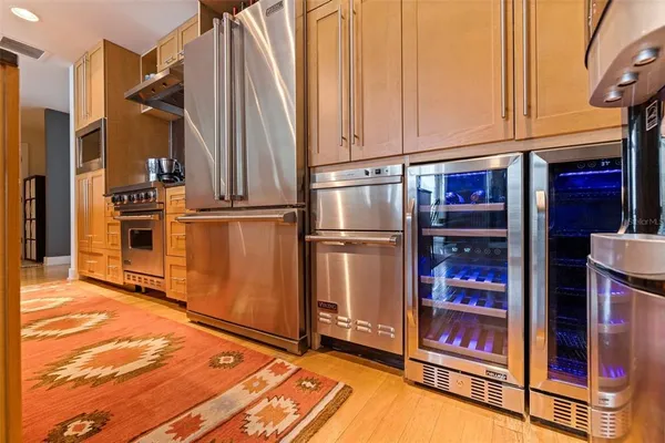 a view of a kitchen with stainless steel appliances and cabinets