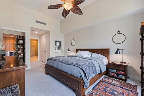 a bedroom with a bed and a chandelier