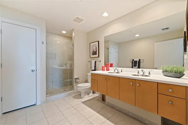 a bathroom with a sink mirror and toilet