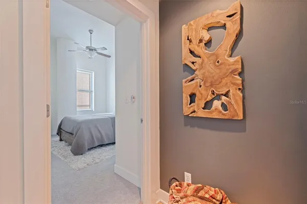 a bedroom with a bed and a painting on the wall