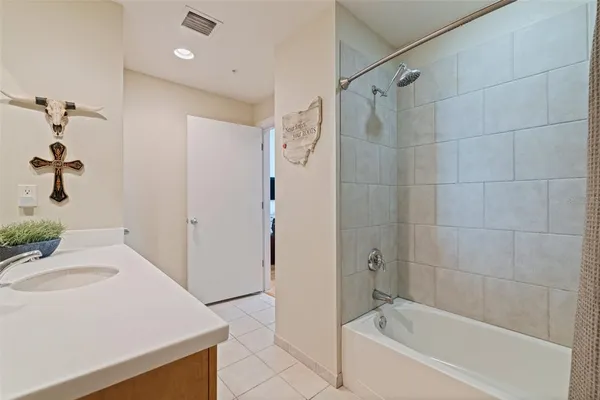 a bathroom with a tub a sink and a shower