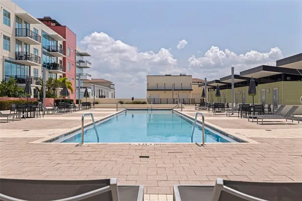 a view of a swimming pool with an outdoor seating
