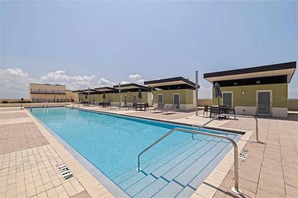 a swimming pool with outdoor seating and city view