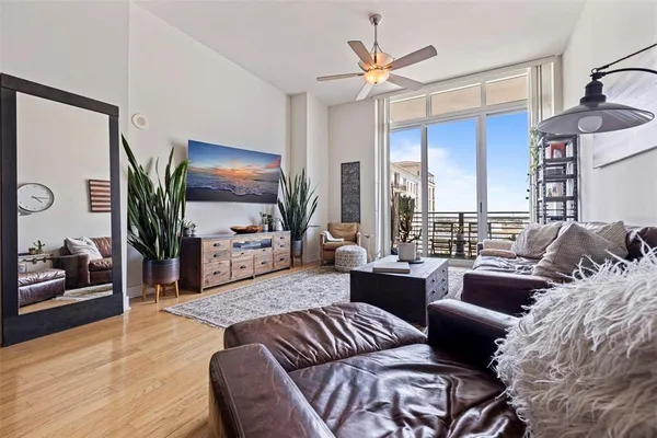 a living room with furniture ceiling fan and a rug