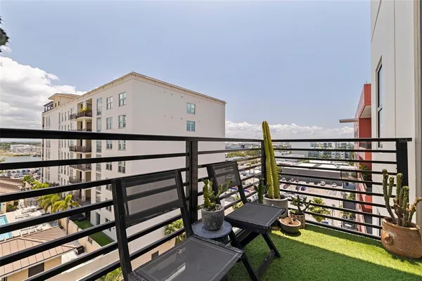 a view of a chairs and table in a balcony