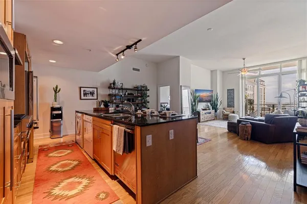 a large kitchen with stainless steel appliances kitchen island granite countertop a large counter top and stainless steel appliances