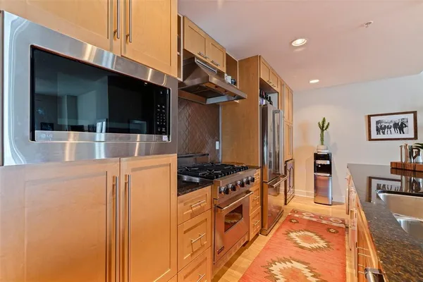 a kitchen with stainless steel appliances a stove a microwave and a refrigerator