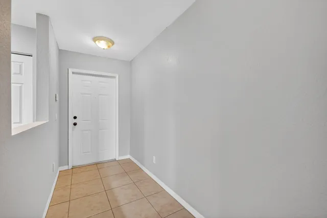 a view of an empty room and closet area