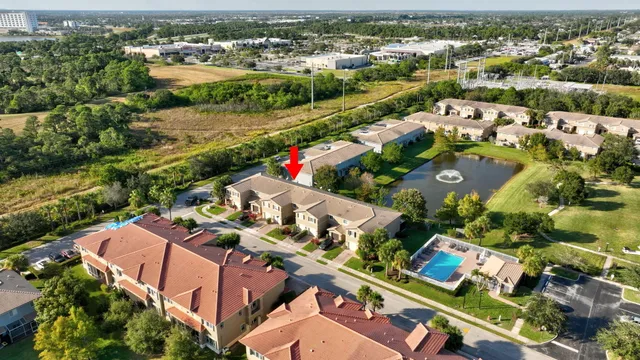 an aerial view of lake and residential houses with outdoor space