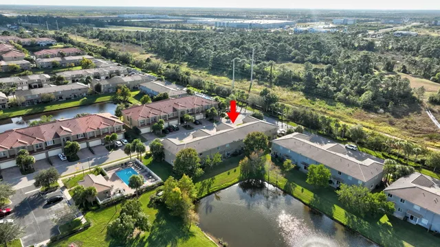 an aerial view of lake and residential houses with outdoor space
