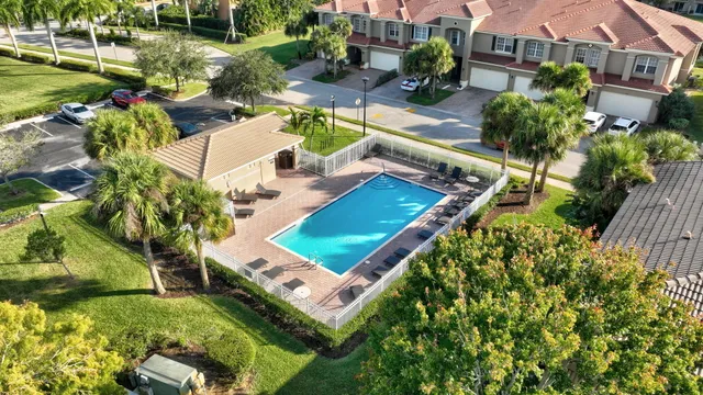 a view of swimming pool with lounge chair in front of house
