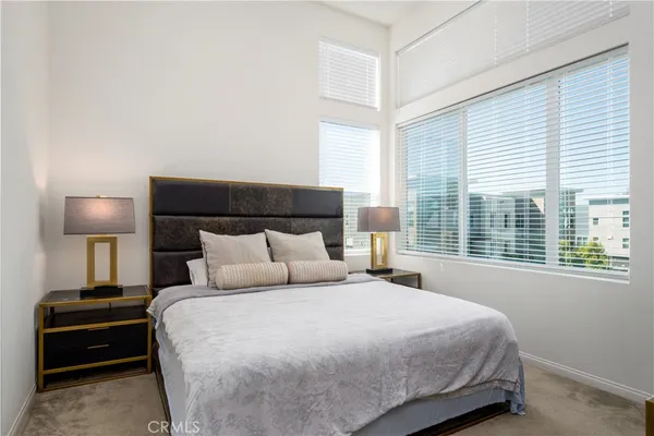 a bedroom with a bed and a night stand