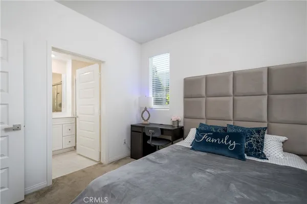 a spacious bedroom with a bed and a cabinets