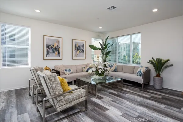 a living room with furniture potted plant and a window