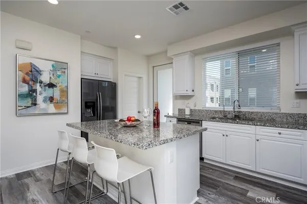 a kitchen with stainless steel appliances granite countertop a sink and cabinets