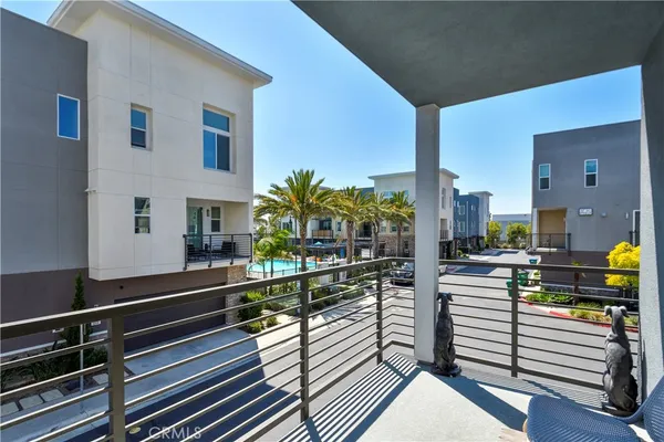 a view of a balcony with chairs and wooden floor