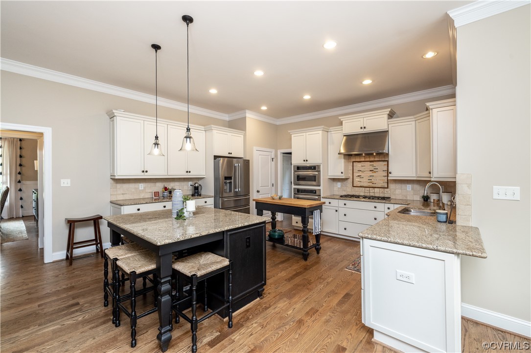 11724 Winterpock Road Chesterfield, VA 23838 - Photo 18 of 50 a kitchen with stainless steel appliances kitchen island granite countertop a sink a stove a dining table chairs and view living room