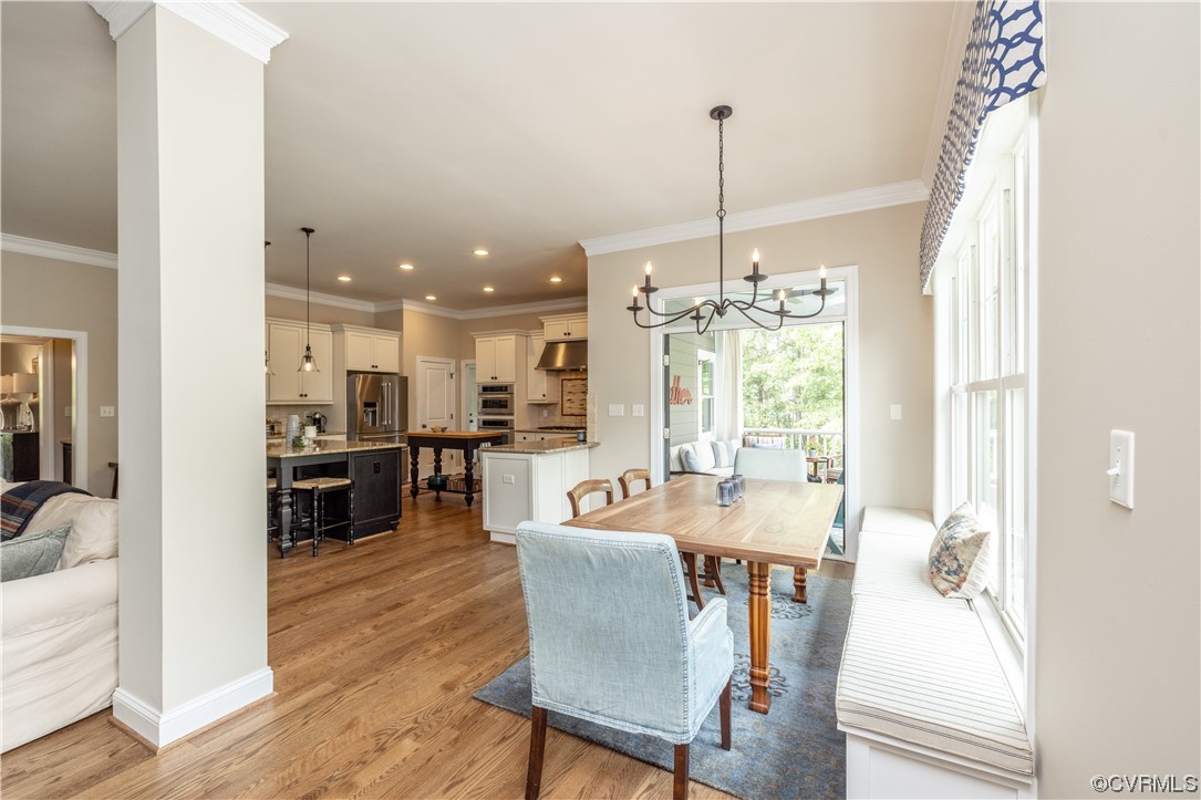 11724 Winterpock Road Chesterfield, VA 23838 - Photo 21 of 50 a dining room with furniture a chandelier and wooden floor
