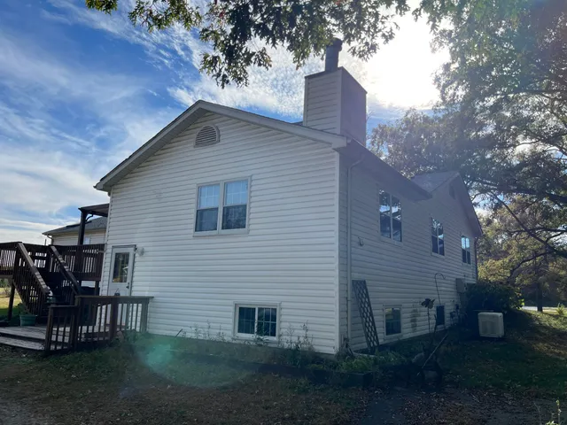a backyard of a house with table and chairs