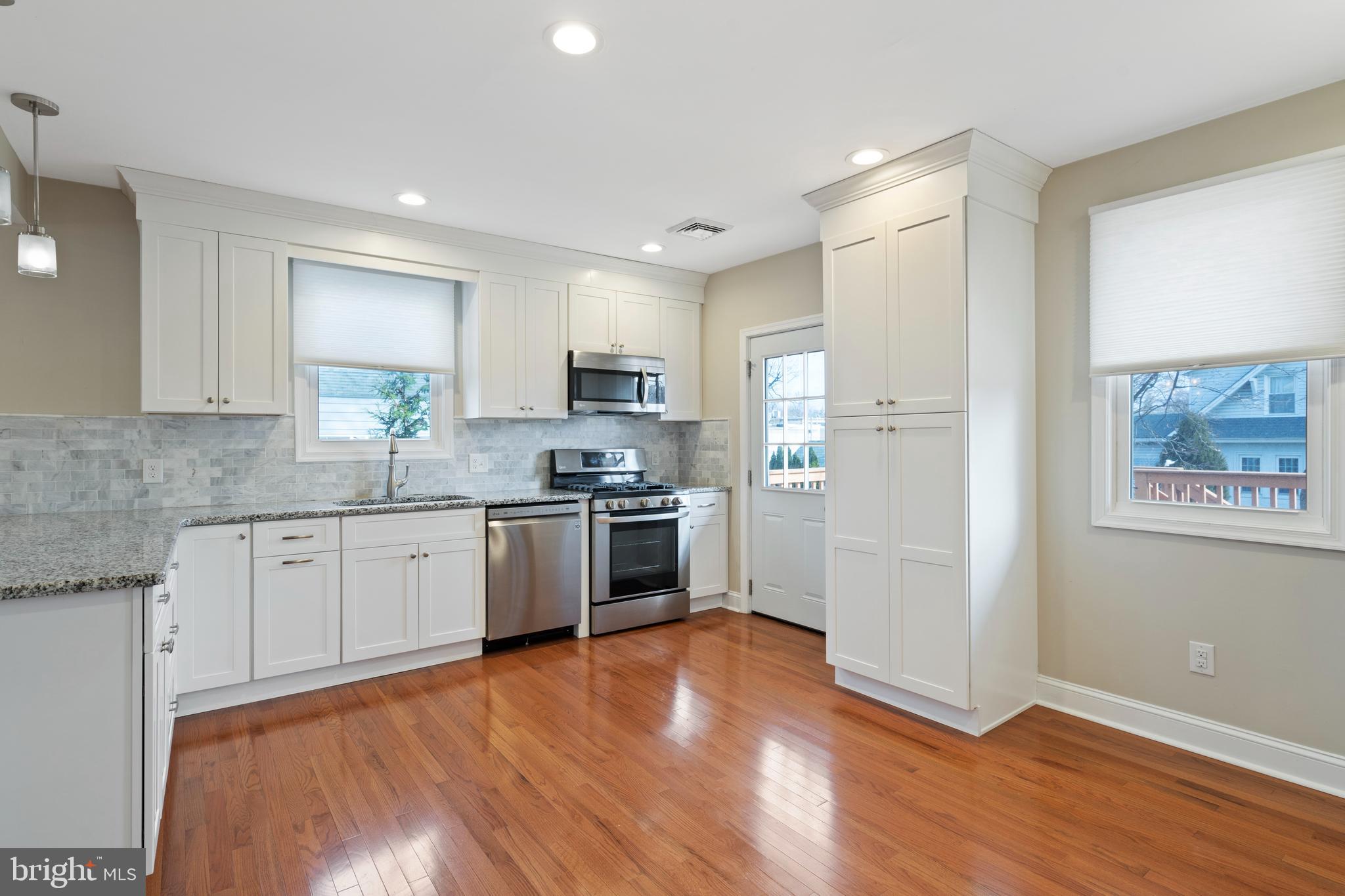 1201 Darby Road Havertown, PA 19083 - Photo 22 of 37 Bright white cabinets are accented by granite
