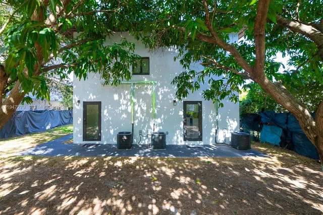 a view of a house with a tree