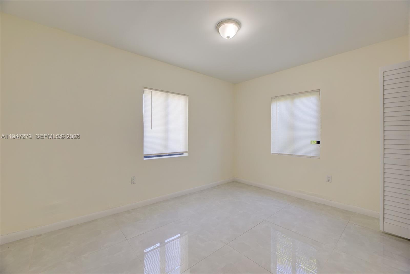 742 Northwest 70th Street, Unit 1 Miami, FL 33150 - Photo 8 of 30 an empty room with a window